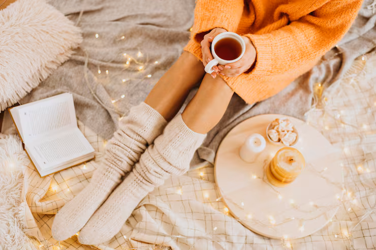 high-angle-woman-enjoying-winter-holidays-with-cup-tea_23-2148802754